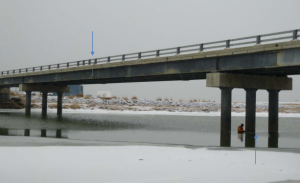 This photo of the Unalakleet bridge shows locations of instrumentation providing data on water levels.