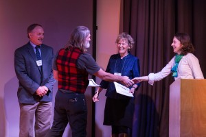 AOOS Film Contest grand prize winner Charlie Ess is congratulated by AOOS Board Chair Ed Page, Executive Director Molly McCammon, and program manager Darcy Dugan